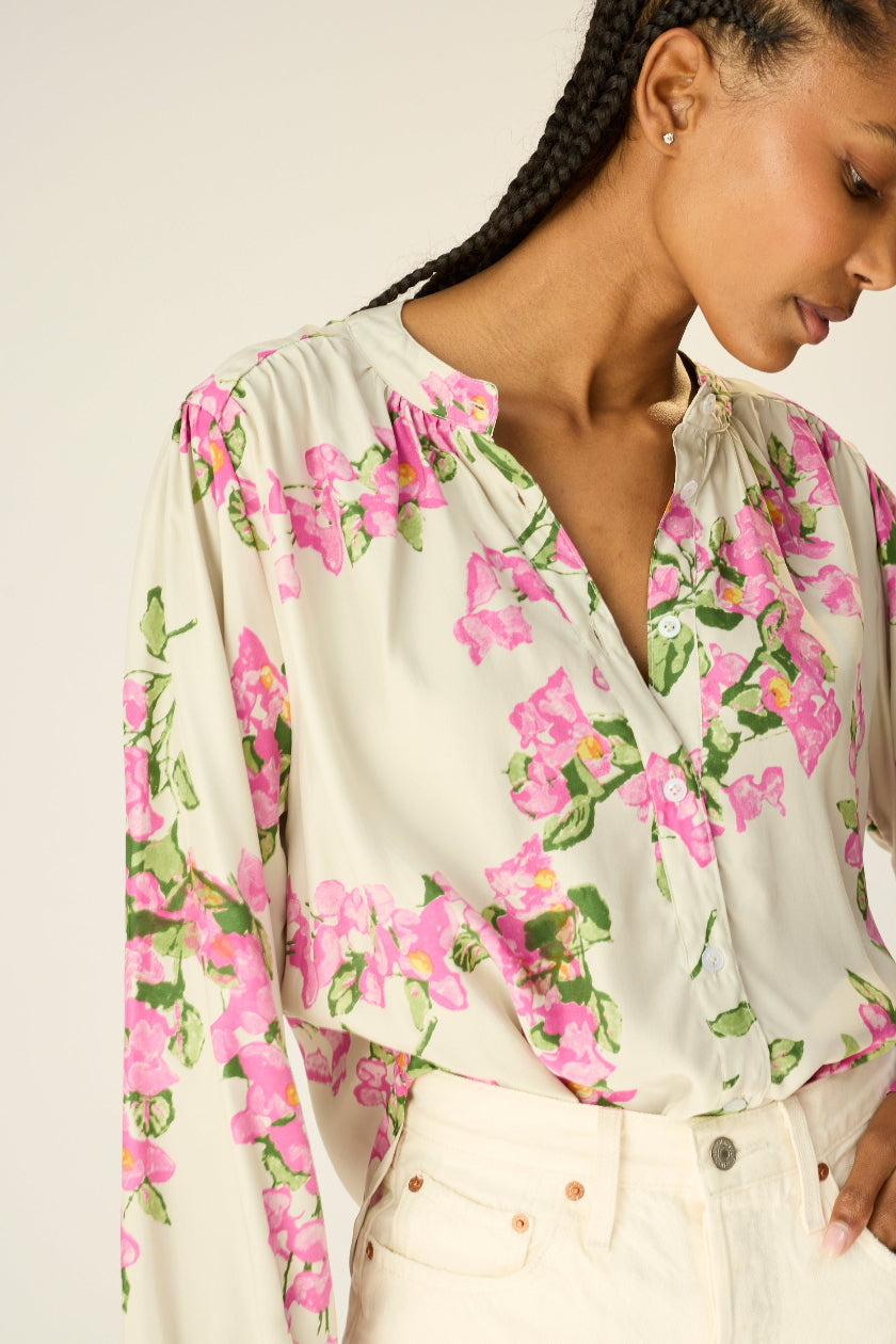 long sleeve button down shirt with band collar. flat cuffs with button closure at wrist. slightly pleated under collar and at shoulders to add fullness.