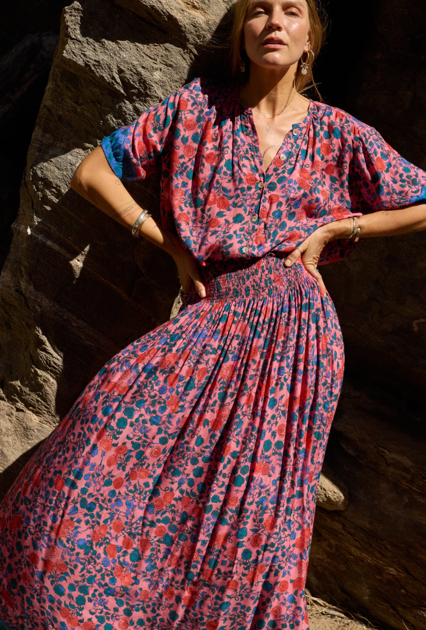 V-neck blouse with shell buttons. Short sleeves with button closure at cuff. Slightly pleated under collar to add body.