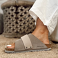 the Kyoto slide offers effortless comfort with a suede upper, nubuck leather straps, and an adjustable hook-and-loop closure for a perfect fit. 