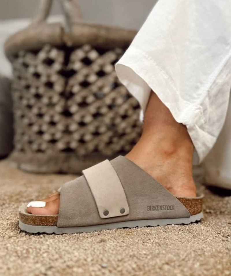 the Kyoto slide offers effortless comfort with a suede upper, nubuck leather straps, and an adjustable hook-and-loop closure for a perfect fit. 