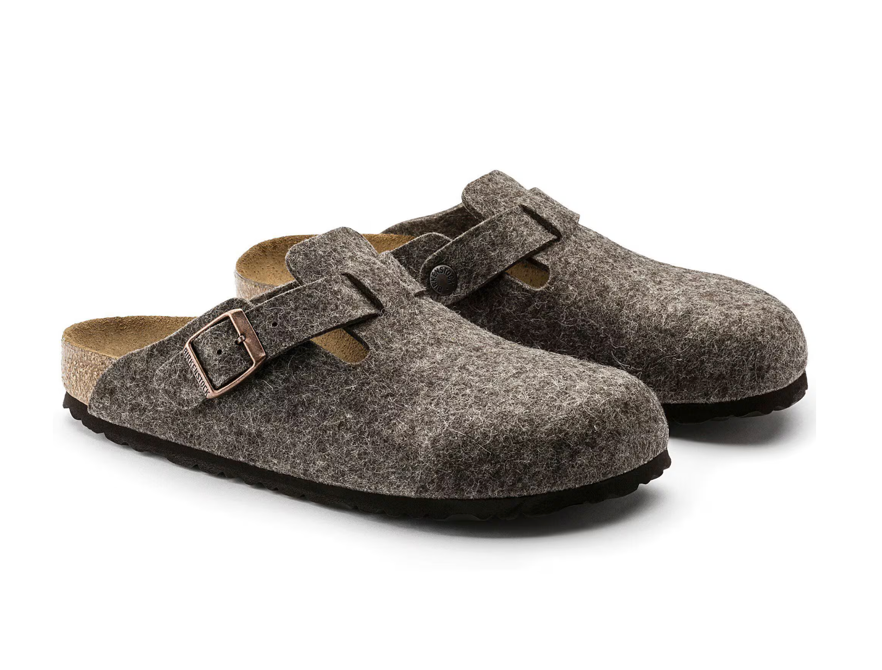 Pair of brown slippers with buckle straps on a white background