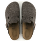 Pair of gray felt clogs with a strap on a white background