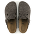 Pair of gray felt clogs with a strap on a white background