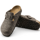 Pair of brown felt clogs on a white background