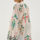 Woman wearing a floral blouse with a plain background
