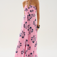 Woman wearing a pink floral dress on a white background