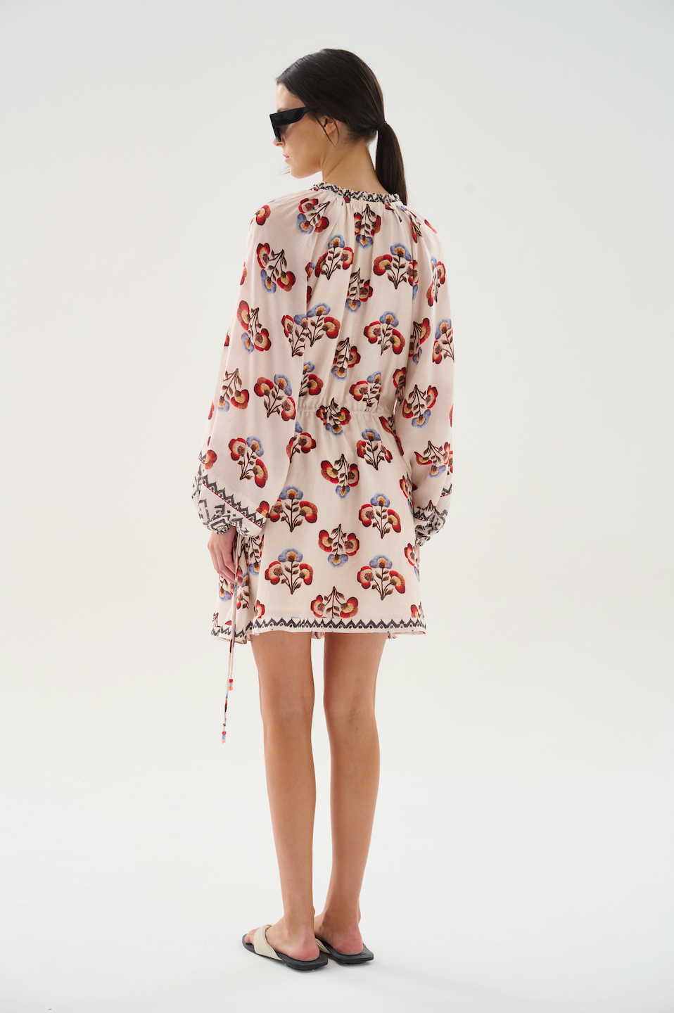 Light and effortless, this short dress is crafted from cupro voile. Designed with a V-neckline that can be fastened with a button, billowy sleeves, and an adjustable waist tie, it balances ease and refinement. Perfect for any occasion.

100% Cupro Voile. 

Hand wash with cool water. Do not bleach. Soft Iron. Do not twist. Dry flat in the shade.

Fitting advice - Loose fit.