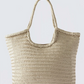 Beige woven tote bag on a light gray background