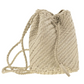 Woven beige bucket bag with drawstring on a white background