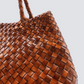 The Santa Croce bag is formed of irregular leather weaving straps that taper towards the brim, creating a practical yet elegant shape that’s perfect for running around the city—taking your outfit from day to night. Remaining true to traditional basket weaving techniques, the Santa Croce comes unlined and has an open top.

An antiqued St. Christopher medal charm, in homage to the patron saint of travellers, is hand-sewn inside each and every Dragon Diffusion bag—our brand’s very own seal of authenticity.