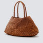 Brown woven handbag on a light gray background