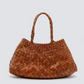The Santa Croce bag is formed of irregular leather weaving straps that taper towards the brim, creating a practical yet elegant shape that’s perfect for running around the city—taking your outfit from day to night. Remaining true to traditional basket weaving techniques, the Santa Croce comes unlined and has an open top.

An antiqued St. Christopher medal charm, in homage to the patron saint of travellers, is hand-sewn inside each and every Dragon Diffusion bag—our brand’s very own seal of authenticity.