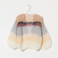 The Boucle Stripes Bomber, a timeless and sophisticated favorite, knit by hand with a luxurious boucle yarn that adds texture and a dry, comfortable touch for the changing season.