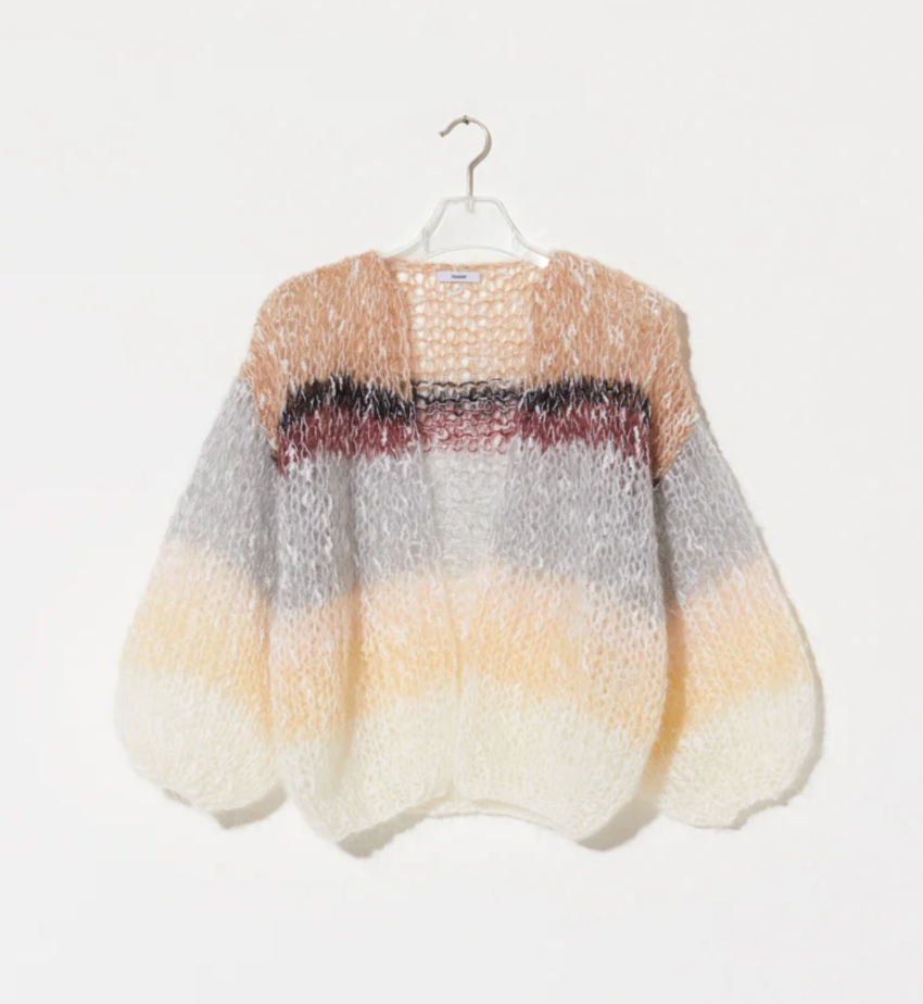 The Boucle Stripes Bomber, a timeless and sophisticated favorite, knit by hand with a luxurious boucle yarn that adds texture and a dry, comfortable touch for the changing season.