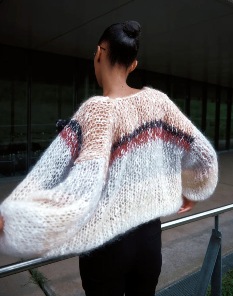 The Boucle Stripes Bomber, a timeless and sophisticated favorite, knit by hand with a luxurious boucle yarn that adds texture and a dry, comfortable touch for the changing season.