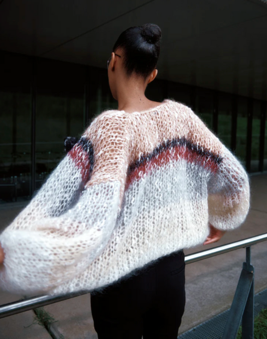 The Boucle Stripes Bomber, a timeless and sophisticated favorite, knit by hand with a luxurious boucle yarn that adds texture and a dry, comfortable touch for the changing season.