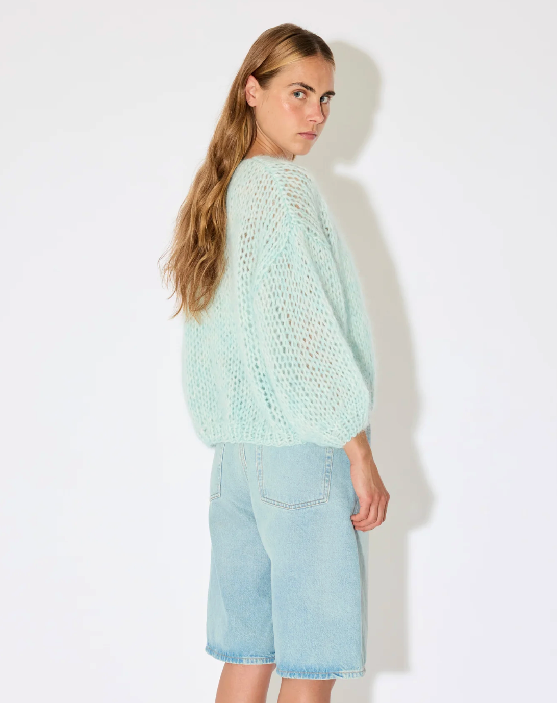 Maiami’s iconic mohair bomber cardigan, defined by its airy volume and signature fluffy texture. Knitted from a soft mohair blend, the cardigan features a relaxed silhouette with gently rounded sleeves and an open front. The lightweight yet warm knit creates a cloud-like feel, while the tactile surface and effortless shape make it a distinctive everyday luxury piece.