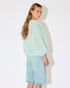 Maiami’s iconic mohair bomber cardigan, defined by its airy volume and signature fluffy texture. Knitted from a soft mohair blend, the cardigan features a relaxed silhouette with gently rounded sleeves and an open front. The lightweight yet warm knit creates a cloud-like feel, while the tactile surface and effortless shape make it a distinctive everyday luxury piece.