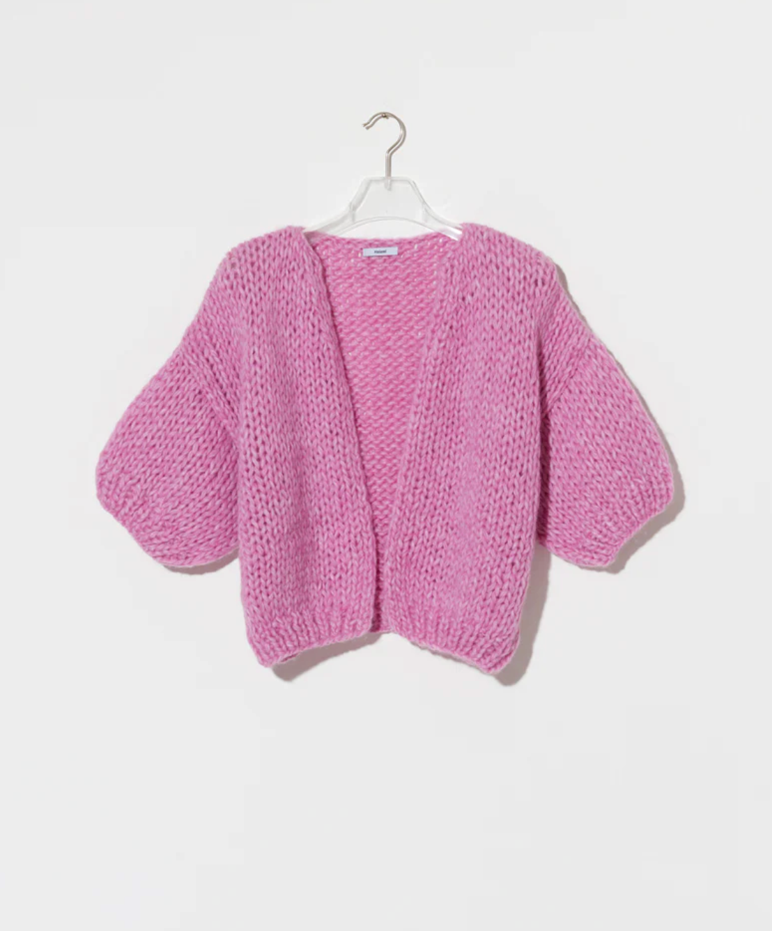 a tactile knit with a relaxed silhouette and short sleeves. Knitted from a fluffy alpaca blend, the cardigan offers warmth with a light, airy feel while the voluminous texture gives the piece a distinctive handcrafted character.

The shorter sleeve length creates a modern proportion, making it an effortless layering piece for transitional seasons.