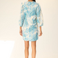 Woman wearing a blue floral dress on a white background