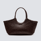 Named after the sunny Massachusetts island, the Nantucket bag is one of our most popular styles. Handwoven in a tight knit from soft buffalo calf leather and complete with braided handles, this roomy, unlined, open-top tote will be the perfect accompaniment to laid-back picnics beneath the summer sun.

An antiqued St. Christopher medal charm, in homage to the patron saint of travellers, is hand-sewn inside each and every Dragon Diffusion bag—our brand’s very own seal of authenticity.