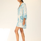 Woman wearing a blue floral dress on a white background