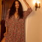 Maxi-length dress with v-neckline and pleated bib.

Three-quarter length sleeves.