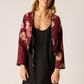 Thinly quilted jacket with self-tie closure at front.

Poppy Combo is reversible.