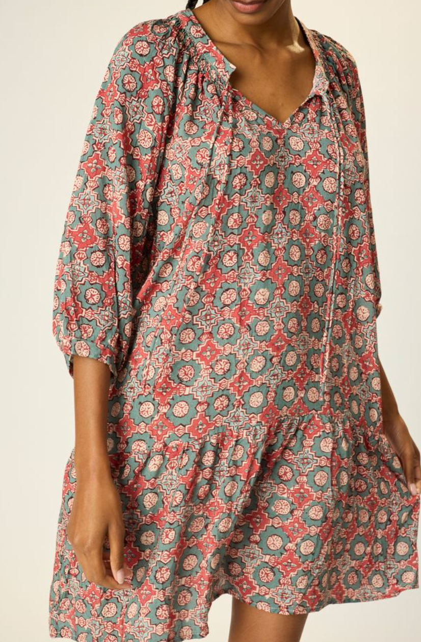 Woman wearing a floral dress with a neutral background