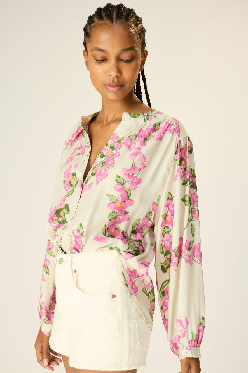 long sleeve button down shirt with band collar. flat cuffs with button closure at wrist. slightly pleated under collar and at shoulders to add fullness.