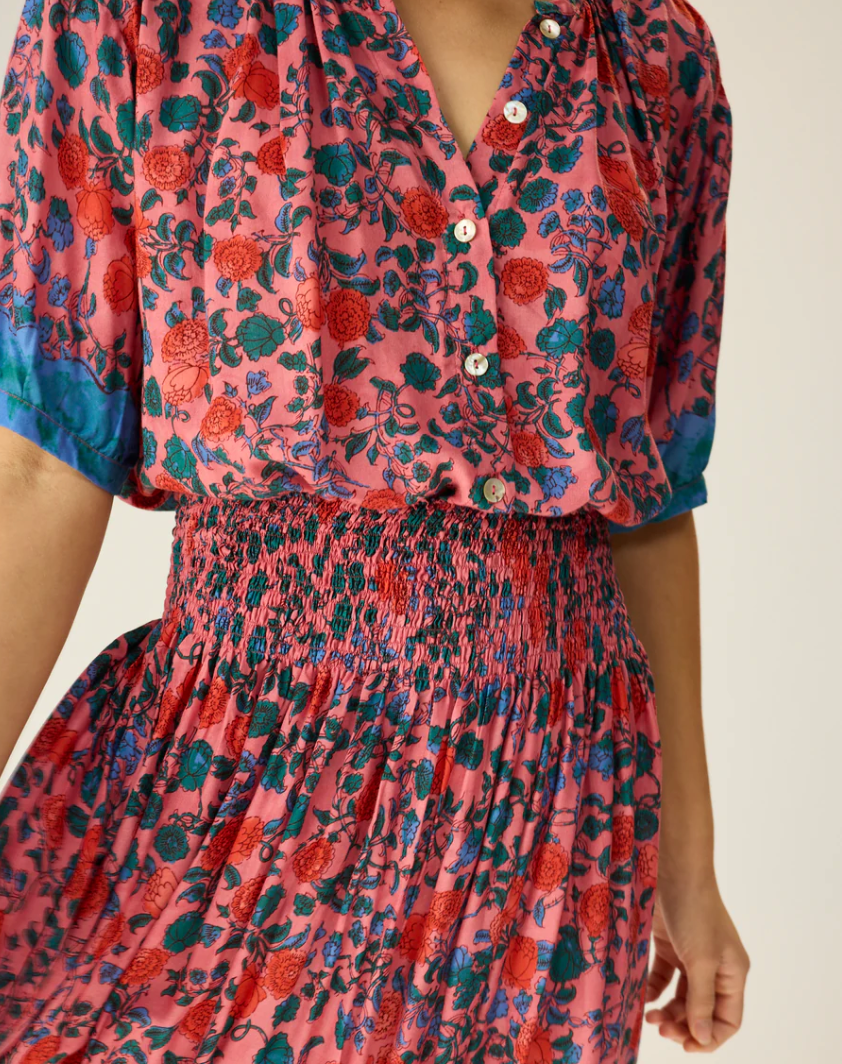 V-neck blouse with shell buttons. Short sleeves with button closure at cuff. Slightly pleated under collar to add body.