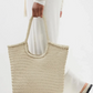 The "NS Diagonal Triple Jump" is a shoulder bag that stands out with its handwoven buffalo calf leather and stylish vertical design. It's deep, unlined, and has an open top, making it easy to fit everything you need. The braided handles not only look great but are comfortable to carry too. This bag gives off Nantucket tote vibes but in a fresh, vertical twist. It’s perfect for anyone looking for a blend of casual elegance and practicality.

An antiqued St. Christopher medal charm, in homage to the patron sa