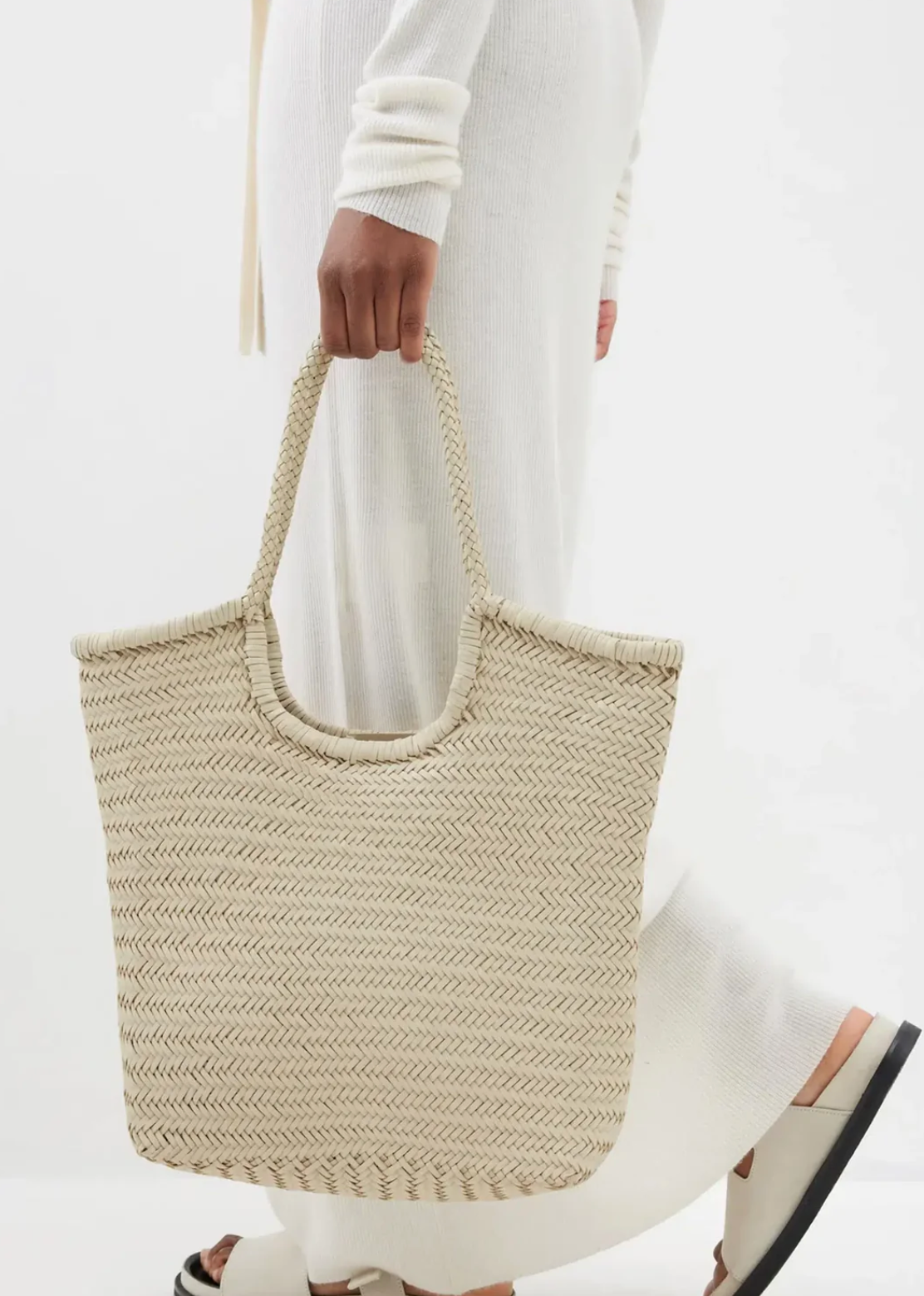 The "NS Diagonal Triple Jump" is a shoulder bag that stands out with its handwoven buffalo calf leather and stylish vertical design. It's deep, unlined, and has an open top, making it easy to fit everything you need. The braided handles not only look great but are comfortable to carry too. This bag gives off Nantucket tote vibes but in a fresh, vertical twist. It’s perfect for anyone looking for a blend of casual elegance and practicality.

An antiqued St. Christopher medal charm, in homage to the patron sa