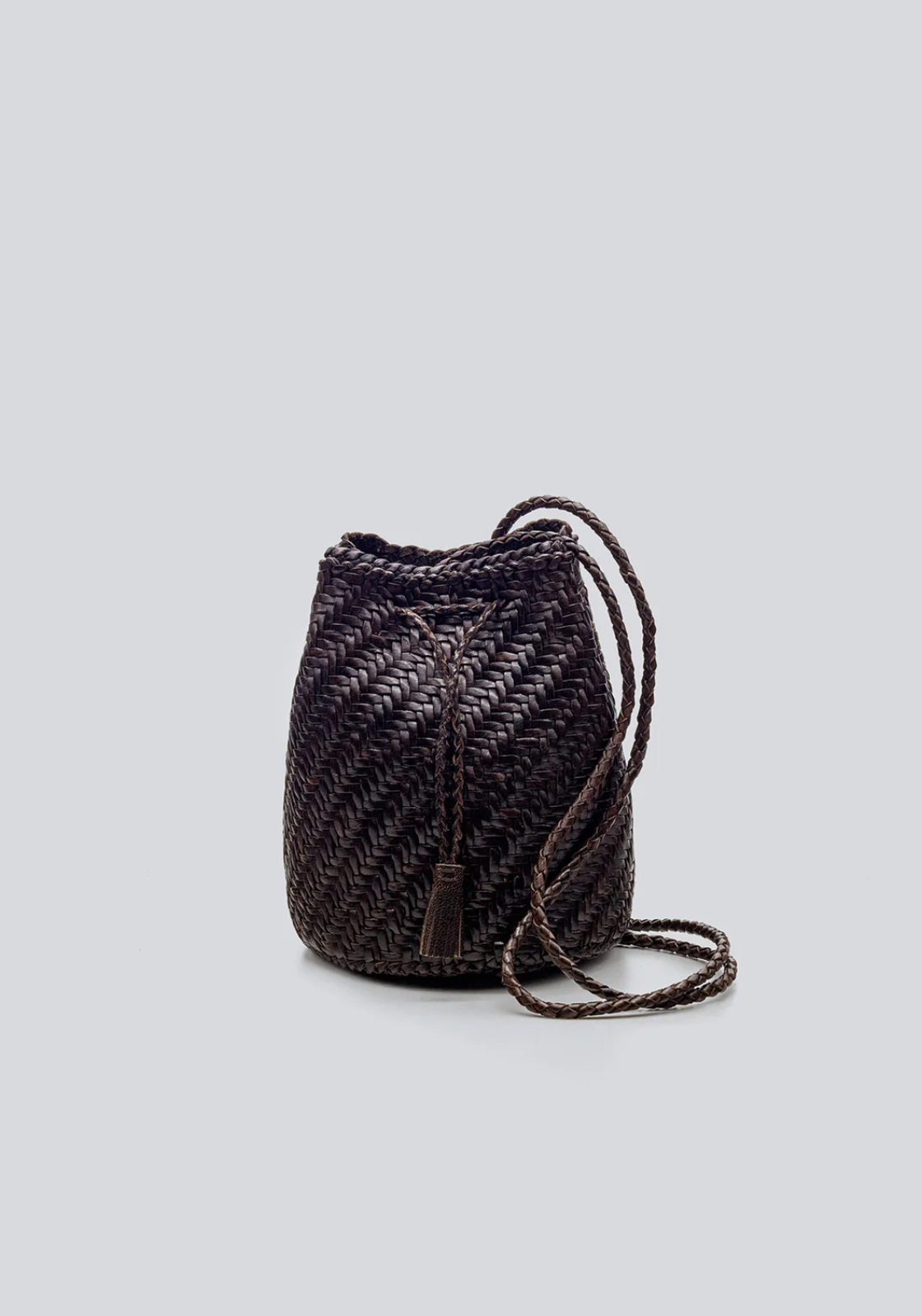 Woven bucket bag with drawstring on a light gray background