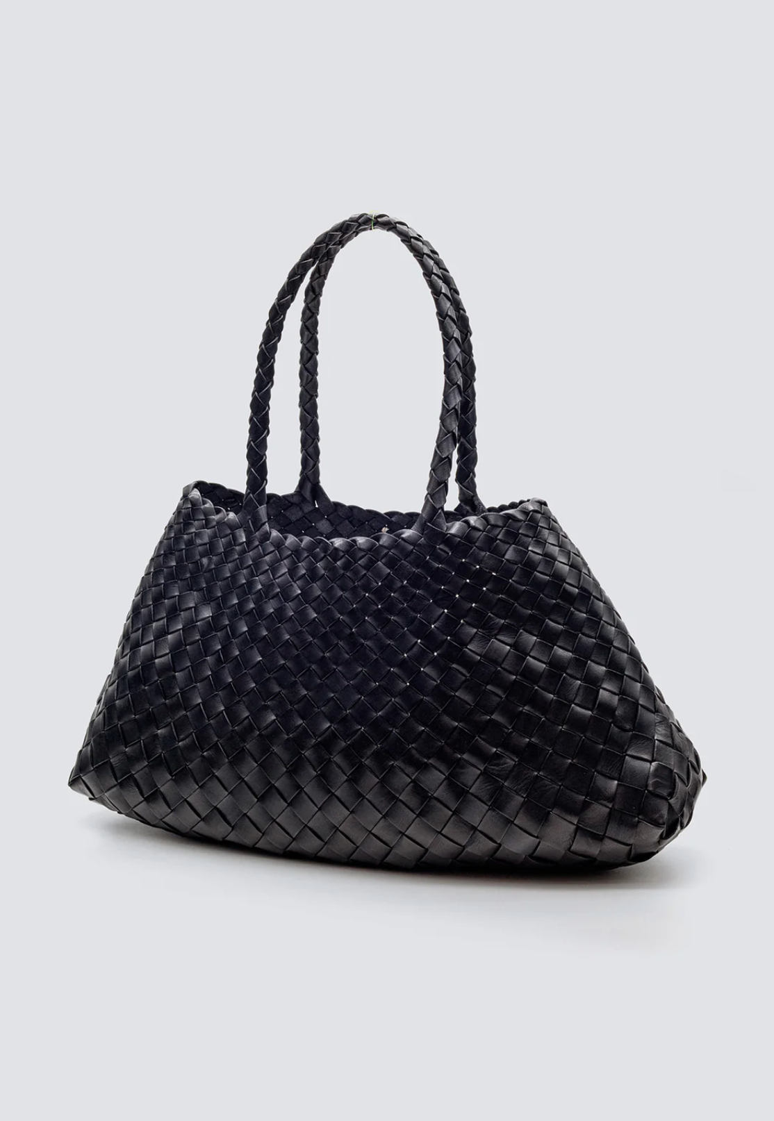 The Santa Croce bag is formed of irregular leather weaving straps that taper towards the brim, creating a practical yet elegant shape that’s perfect for running around the city—taking your outfit from day to night. Remaining true to traditional basket weaving techniques, the Santa Croce comes unlined and has an open top.

An antiqued St. Christopher medal charm, in homage to the patron saint of travellers, is hand-sewn inside each and every Dragon Diffusion bag—our brand’s very own seal of authenticity.