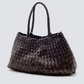 The Santa Croce bag is formed of irregular leather weaving straps that taper towards the brim, creating a practical yet elegant shape that’s perfect for running around the city—taking your outfit from day to night. Remaining true to traditional basket weaving techniques, the Santa Croce comes unlined and has an open top.

An antiqued St. Christopher medal charm, in homage to the patron saint of travellers, is hand-sewn inside each and every Dragon Diffusion bag—our brand’s very own seal of authenticity.