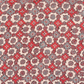Patterned fabric with red, blue, and beige colors on a beige background