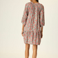 Woman wearing a patterned dress on a white background
100% rayon 