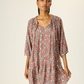 Mid-length dress with drop waist.
Gathered collar with four tassels.
Half-sleeve.